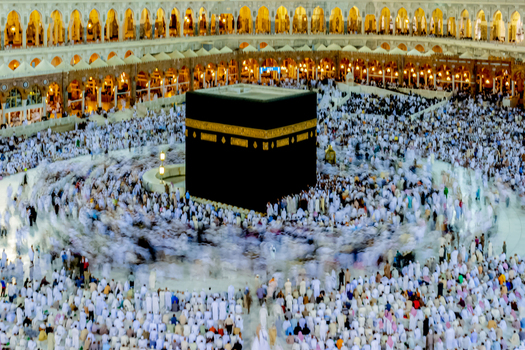 Aerial view of the Kaaba at the center of Masjid al Haram with a large crowd of pilgrims circling the structure in Makkah Makkah Province Saudi Arabia. Aerial view of the Kaaba at the center of Masjid al Haram with a large crowd of pilgrims circling the structure in Makkah Makkah Province Saudi Arabia.