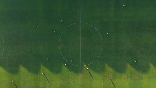 Aerial view of soccer players at Maguwoharjo Stadium Indonesia.