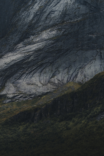 View of the dramatic rocky cliffs and rugged mountain slopes of Lofoten in Nordland Norway.