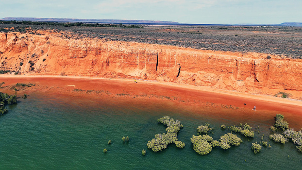 Aerial view of Matthew Flinders Red Cliff Lookout with vibrant red cliffs sandy shoreline and mangroves along the water in Port Augusta West South Australia Australia. Aerial view of Matthew Flinders Red Cliff Lookout with vibrant red cliffs sandy shoreline and mangroves along the water in Port Augusta West South Australia Australia.