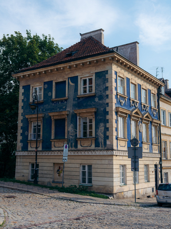 View of a historic building with a blue facade and intricate murals in Warsaw Old Town Warsaw Masovian Voivodeship Poland. View of a historic building with a blue facade and intricate murals in Warsaw Old Town Warsaw Masovian Voivodeship Poland.