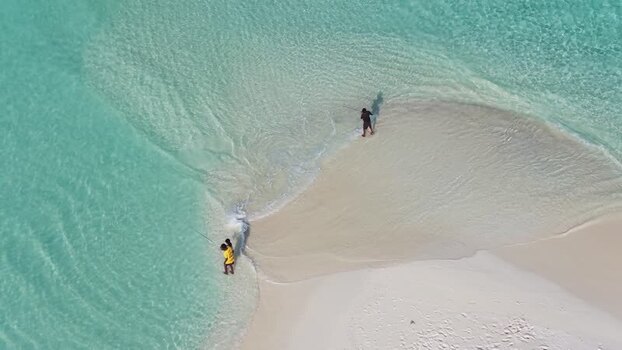 Aerial view of fishermen on a sandbar in Vashafaru Maldives.