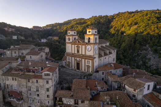 Aerial view of the Church of Santa Maria in the historic town of Artena with traditional stone buildings and terracotta rooftops nestled in the hills of Artena Lazio Italy.