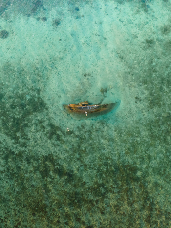 Aerial view of a shipwreck resting peacefully beneath the turquoise waters a silent testament to time in Goro South Province New Caledonia. Aerial view of a shipwreck resting peacefully beneath the turquoise waters a silent testament to time in Goro South Province New Caledonia.