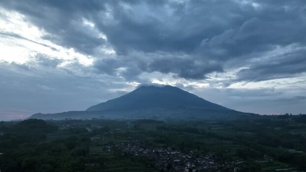 Aerial view of a mountain under cloudy sky in Indonesia. Aerial view of a mountain under cloudy sky in Indonesia.