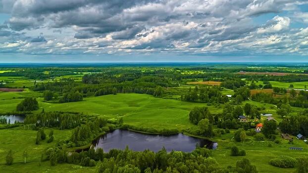Aerial view of lush green landscape and lake in Latvia. Aerial view of lush green landscape and lake in Latvia.