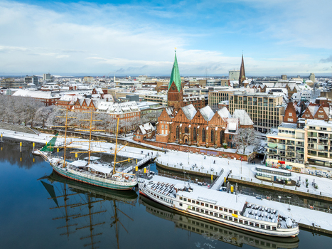 Aerial view of St. Martin s Church and ships on the snow covered Weser river in Bremen Germany. Aerial view of St. Martin s Church and ships on the snow covered Weser river in Bremen Germany.