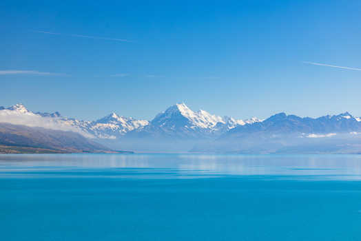 View of turquoise waters mirroring snow capped mountains under a bright blue sky a serene panorama of nature s majesty Lake Pukaki Mount Cook Lookout New Zealand. View of turquoise waters mirroring snow capped mountains under a bright blue sky a serene panorama of nature s majesty Lake Pukaki Mount Cook Lookout New Zealand.