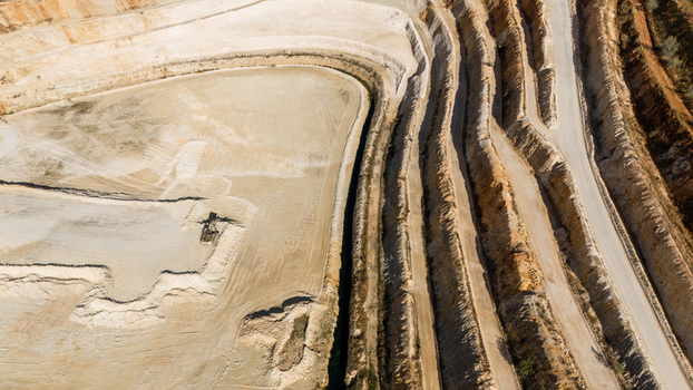 Aerial view of the open pit mine in Besenovo with terraced excavation walls and dirt roads winding through the industrial landscape in Besenovo Vojvodina Serbia. Aerial view of the open pit mine in Besenovo with terraced excavation walls and dirt roads winding through the industrial landscape in Besenovo Vojvodina Serbia.