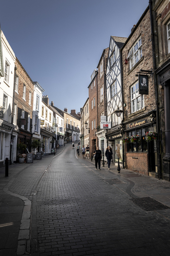 Durham United Kingdom 13 July 2026 View of a historic street in Durham with traditional brick and timber framed buildings cobblestone pavement and pedestrians under a clear blue sky. Durham United Kingdom 13 July 2026 View of a historic street in Durham with traditional brick and timber framed buildings cobblestone pavement and pedestrians under a clear blue sky.
