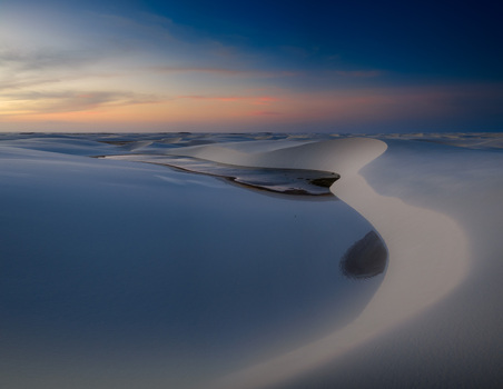 Aerial view of Parque Nacional dos Lencois Maranhenses with white sand dunes and freshwater lagoons under a sunset sky Lencois Maranhenses MA Brazil. Aerial view of Parque Nacional dos Lencois Maranhenses with white sand dunes and freshwater lagoons under a sunset sky Lencois Maranhenses MA Brazil.
