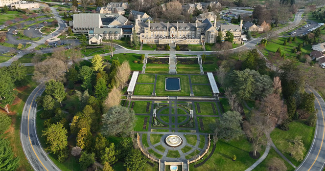 Aerial view of the Masonic Village retirement community campus featuring formal gardens a central fountain and stone architecture in West Donegal Township Pennsylvania United States.