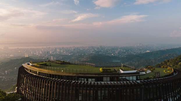 Cebu City Philippines 20 May 2026 Aerial view of the modern circular observation deck in Busay overlooking the urban skyline and the sea under a soft sky.