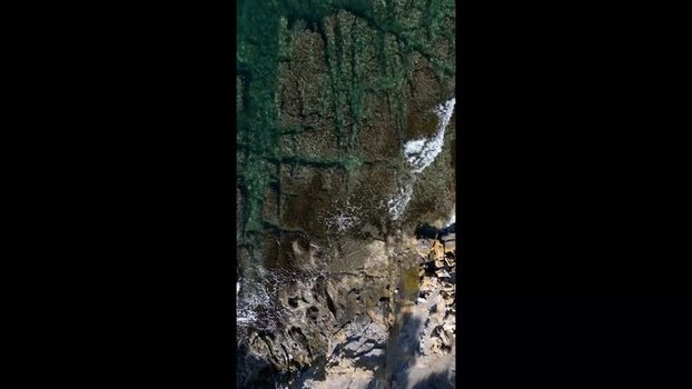 Aerial view of rocky coastline and turquoise water in Moraira Spain.