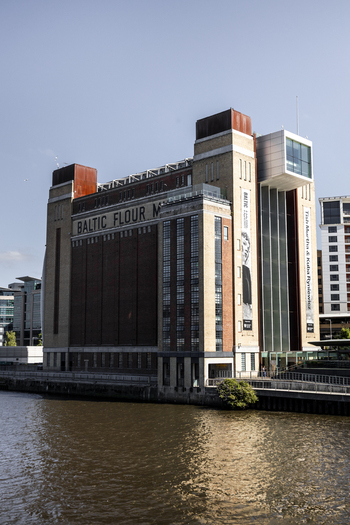 View of the BALTIC Centre for Contemporary Art a former flour mill with distinctive brick architecture situated on the riverfront in Newcastle upon Tyne England United Kingdom. View of the BALTIC Centre for Contemporary Art a former flour mill with distinctive brick architecture situated on the riverfront in Newcastle upon Tyne England United Kingdom.