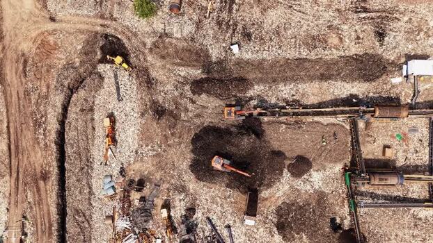 Aerial view of waste recycling facility with heavy machinery India.