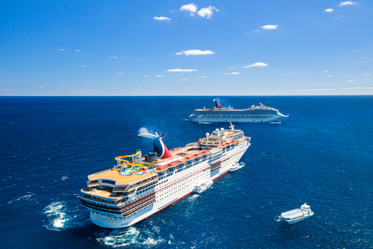 The Berry Islands The Bahamas 02 May 2020 Aerial view of two large cruise ships sailing on the deep blue Caribbean Sea under a clear sky.