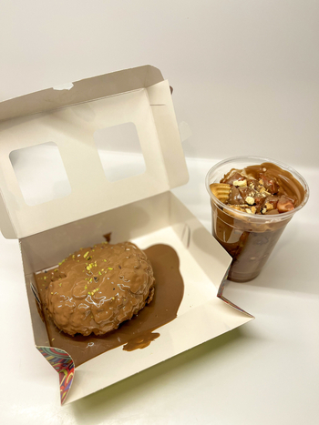 View of a chocolate covered dessert in an open white box and a chocolate cup with toppings Beylikduzu Istanbul Turkiye. View of a chocolate covered dessert in an open white box and a chocolate cup with toppings Beylikduzu Istanbul Turkiye.