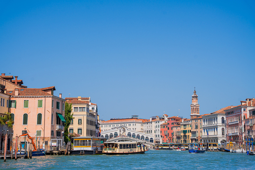 Venice Italy 29 March 2026 View of the Grand Canal shimmering under the clear sky framed by historic buildings and the iconic Rialto Bridge. Venice Italy 29 March 2026 View of the Grand Canal shimmering under the clear sky framed by historic buildings and the iconic Rialto Bridge.