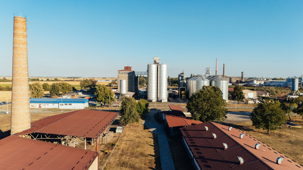 Aerial view of the industrial grain silos and brick chimney at the facility in Sremska Mitrovica Vojvodina Serbia. Aerial view of the industrial grain silos and brick chimney at the facility in Sremska Mitrovica Vojvodina Serbia.