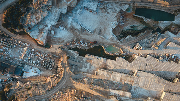 Aerial view of Jadrankamen white stone quarry with terraced excavation sites and blocks of stone in Pucisca Splitsko dalmatinska Croatia. Aerial view of Jadrankamen white stone quarry with terraced excavation sites and blocks of stone in Pucisca Splitsko dalmatinska Croatia.