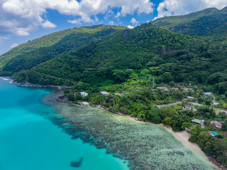 Aerial view of turquoise waters meet lush green hillsides by the coast a tropical paradise of vibrant colors and serene beauty Victoria Mahe Island Seychelles. Aerial view of turquoise waters meet lush green hillsides by the coast a tropical paradise of vibrant colors and serene beauty Victoria Mahe Island Seychelles.