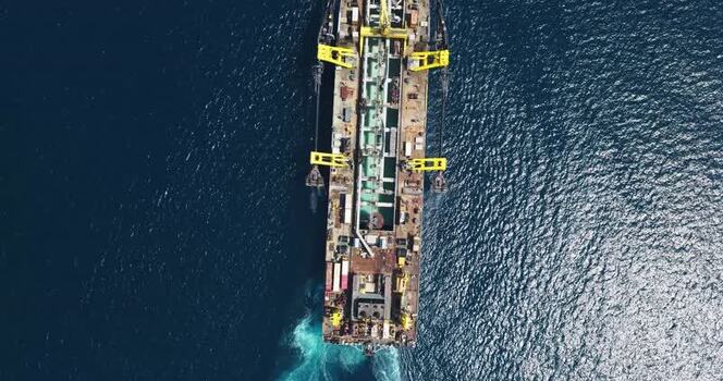 Aerial view of an industrial barge in the deep blue sea Maldives. Aerial view of an industrial barge in the deep blue sea Maldives.
