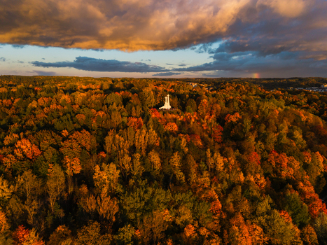 Aerial view of the Three Crosses Monument standing starkly against a sea of autumnal trees under a dramatic sky Vilnius Lithuania. Aerial view of the Three Crosses Monument standing starkly against a sea of autumnal trees under a dramatic sky Vilnius Lithuania.