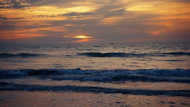 View of the sunset over the waves at Cox s Bazar Bangladesh. View of the sunset over the waves at Cox s Bazar Bangladesh.