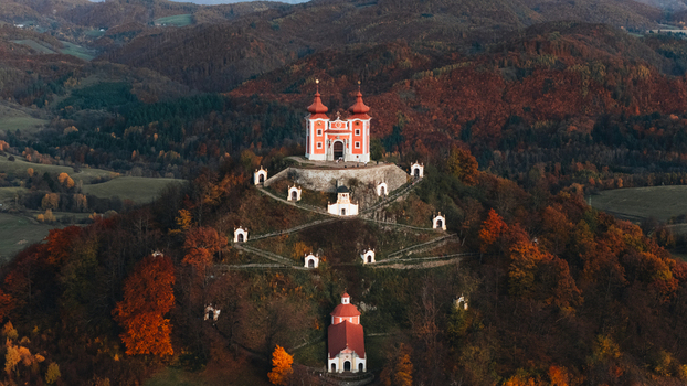 Aerial view of the Kalvaria Banska Stiavnica complex on a hill surrounded by autumn forests in Banska Stiavnica Banskobystricky kraj Slovakia.