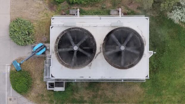 Aerial view of industrial cooling fans and a blue boom lift Czechia. Aerial view of industrial cooling fans and a blue boom lift Czechia.