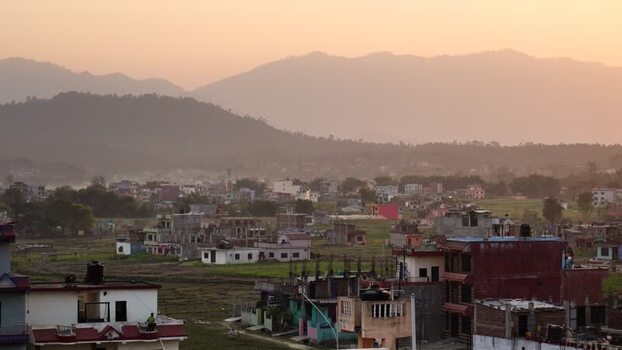 View of a town with colorful houses and mountains at sunset Nepal.