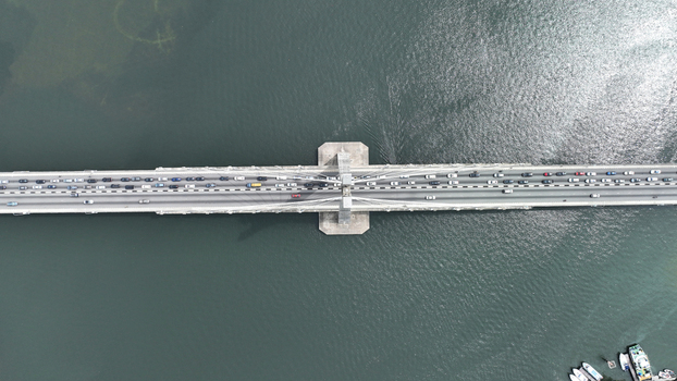 Aerial view of the Lekki Ikoyi Link Bridge with heavy traffic flowing across the cable stayed structure over the water in Lagos Lagos Nigeria.
