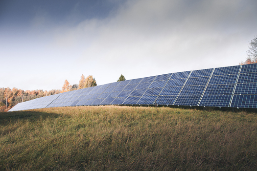 View of a large solar farm with rows of photovoltaic panels installed on a grassy field under a cloudy sky in Otepaa Valga County Estonia. View of a large solar farm with rows of photovoltaic panels installed on a grassy field under a cloudy sky in Otepaa Valga County Estonia.