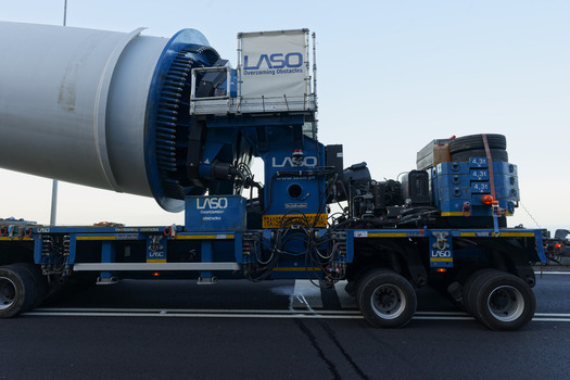 Estreito da Calheta Portugal 20 September 2026 View of a large wind turbine blade being transported on a specialized heavy duty truck on a road. Estreito da Calheta Portugal 20 September 2026 View of a large wind turbine blade being transported on a specialized heavy duty truck on a road.