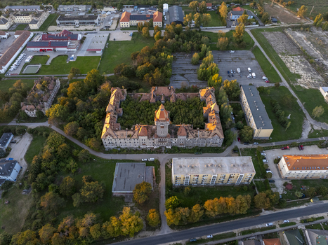 Aerial view of the historic and overgrown Hajmasker Barracks with its distinctive orange tiled roofs and dense vegetation in the central courtyard in Hajmasker Hungary. Aerial view of the historic and overgrown Hajmasker Barracks with its distinctive orange tiled roofs and dense vegetation in the central courtyard in Hajmasker Hungary.
