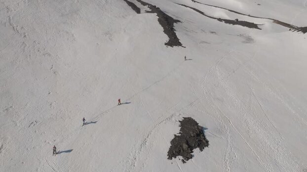 Aerial view of hikers on the snowy slopes of Mount Etna Italy. Aerial view of hikers on the snowy slopes of Mount Etna Italy.