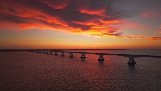 Aerial view of Zeeland Bridge at sunset in Netherlands.