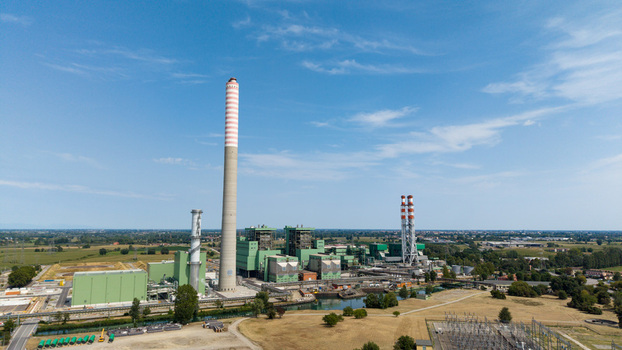 Aerial view of the TTEP Tavazzano thermal power plant and TERNA electrical substation with tall chimneys and industrial buildings in Tavazzano con Villavesco Lombardy Italy.