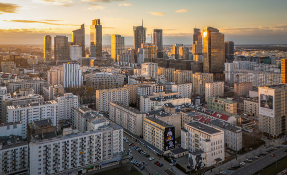 Aerial view of the modern skyscrapers in the business district and residential apartment blocks during golden hour sunset in Warsaw Poland. Aerial view of the modern skyscrapers in the business district and residential apartment blocks during golden hour sunset in Warsaw Poland.