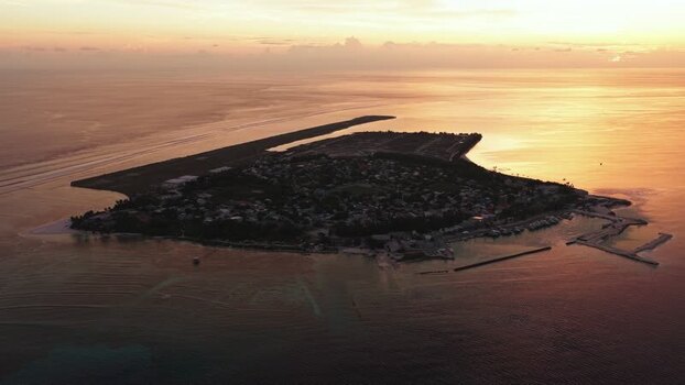Aerial view of Kudahuvadhoo island at sunset Maldives.