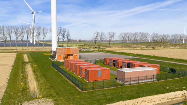 Aerial view of battery storage system at wind park with wind turbines