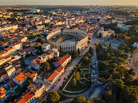 Aerial view of the magnificent Pula Arena standing proudly amidst the vibrant cityscape a testament to ancient Roman architecture Pula Istria County Croatia.