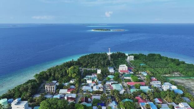 Aerial view of Kamadhoo island with lush vegetation and blue sea Maldives. Aerial view of Kamadhoo island with lush vegetation and blue sea Maldives.