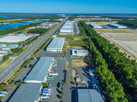 Wilmington United States 27 September 2026 Aerial view of industrial warehouses and distribution centers located along a highway surrounded by pine forests and open land. Wilmington United States 27 September 2026 Aerial view of industrial warehouses and distribution centers located along a highway surrounded by pine forests and open land.