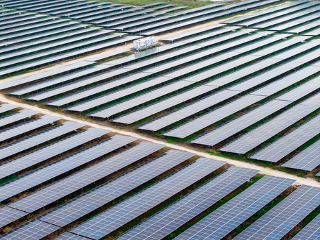 Aerial view of large scale solar photovoltaic power plant with rows of solar panels and a maintenance building in Central Seberang Perai Penang Malaysia. Aerial view of large scale solar photovoltaic power plant with rows of solar panels and a maintenance building in Central Seberang Perai Penang Malaysia.