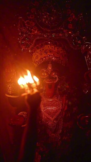 View of a figure holding fire India.