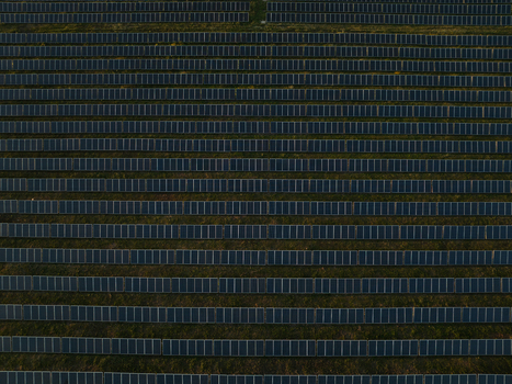Aerial view of rows of solar panels in a large photovoltaic power plant on green fields Augusta Sicily Italy. Aerial view of rows of solar panels in a large photovoltaic power plant on green fields Augusta Sicily Italy.