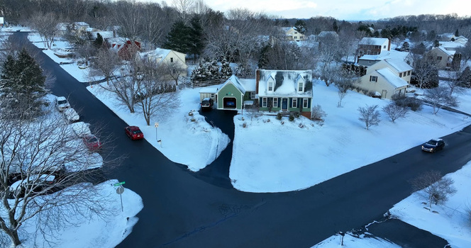 Aerial view of a residential neighborhood in Lititz covered in snow with houses trees and cars on the streets in Lititz Pennsylvania United States. Aerial view of a residential neighborhood in Lititz covered in snow with houses trees and cars on the streets in Lititz Pennsylvania United States.