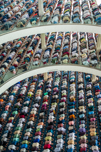 Dhaka Bangladesh 19 June 2026 Aerial view of a large congregation of people praying inside Baitul Mukarram National Mosque with rows of worshippers kneeling on the carpeted floor.